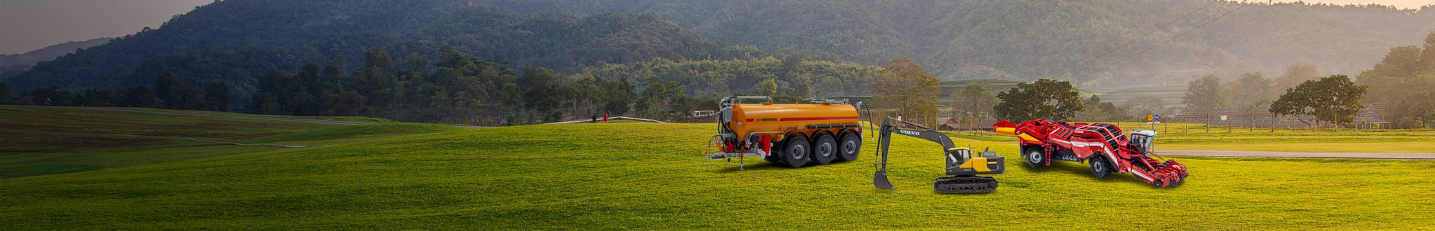 Graslandschap met diverse schaalmodellen van landboumachines en constructiemachines